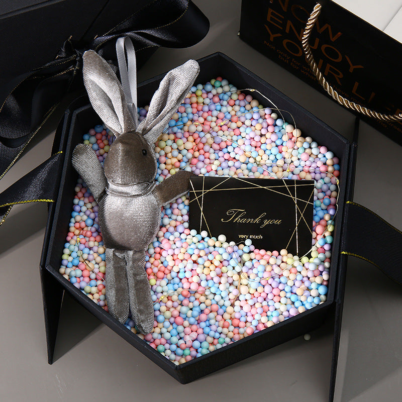 Hexagonal cardboard gift box with bow, close-up