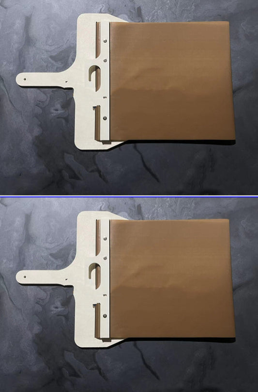 Wooden pizza peel transferring a pizza