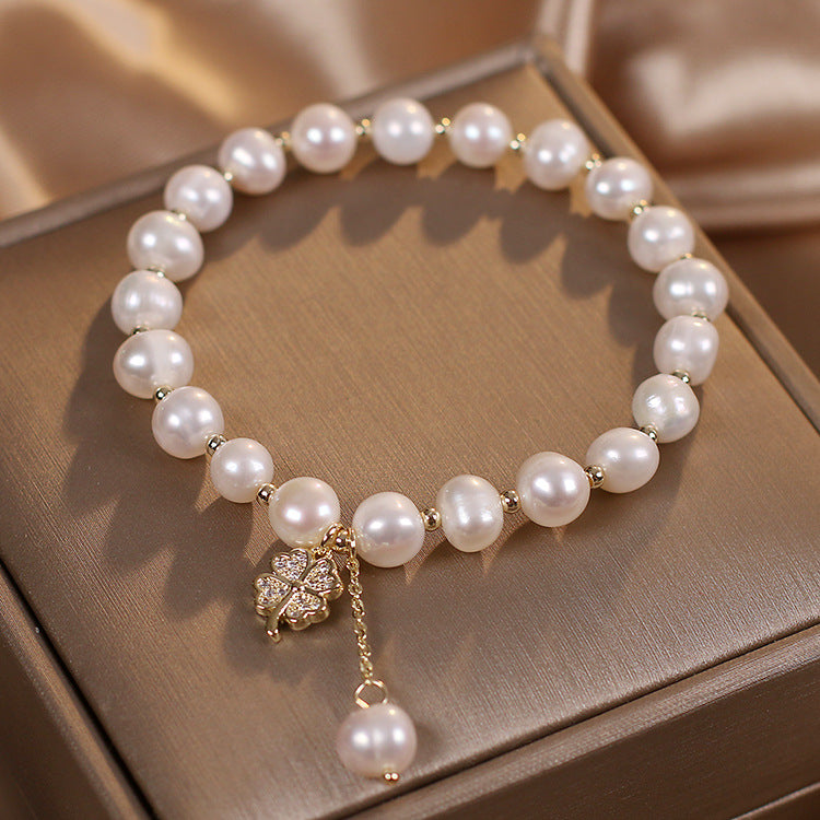Freshwater pearl four-leaf clover bracelet worn on wrist