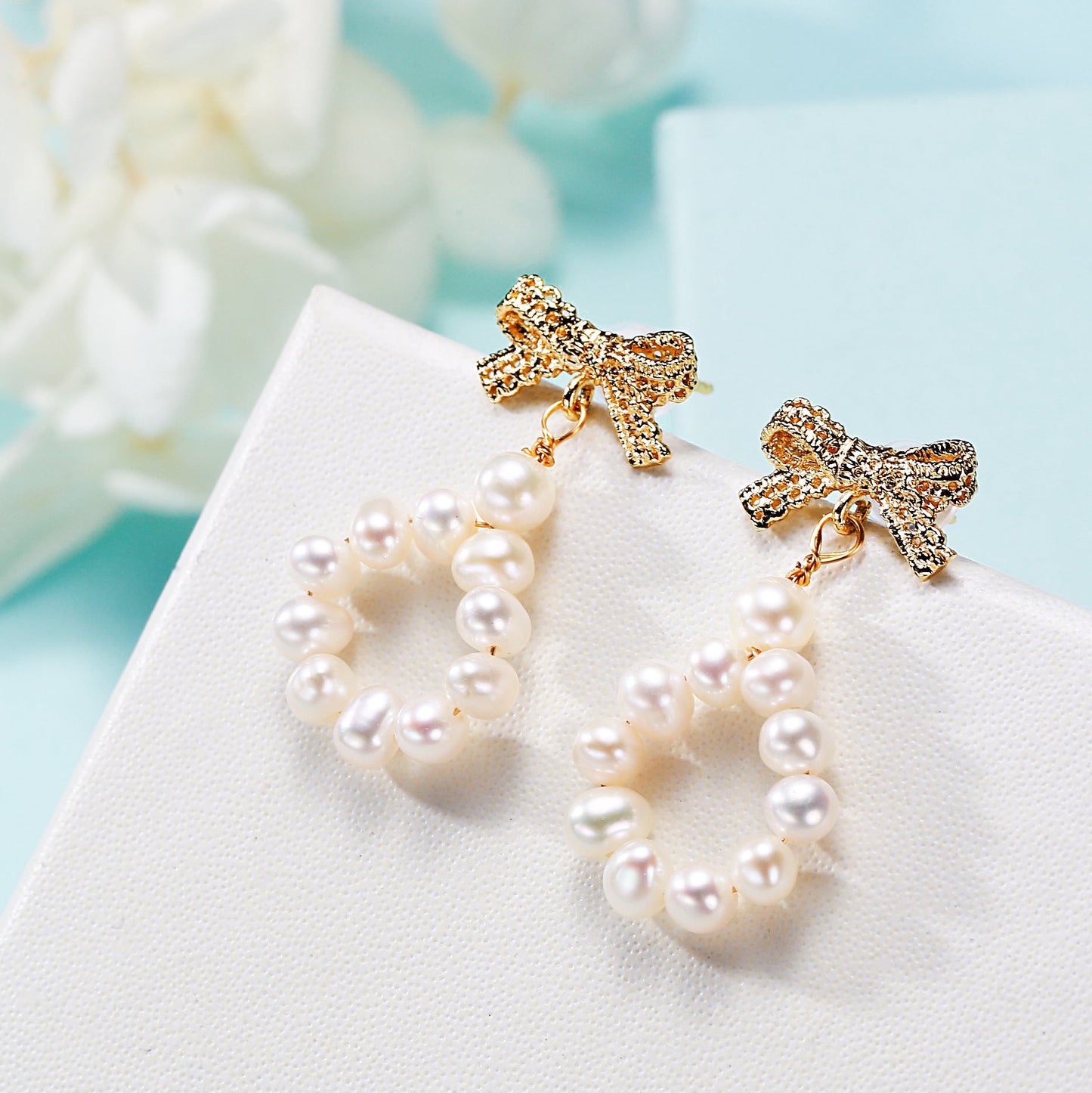Freshwater pearl bow earrings, front view