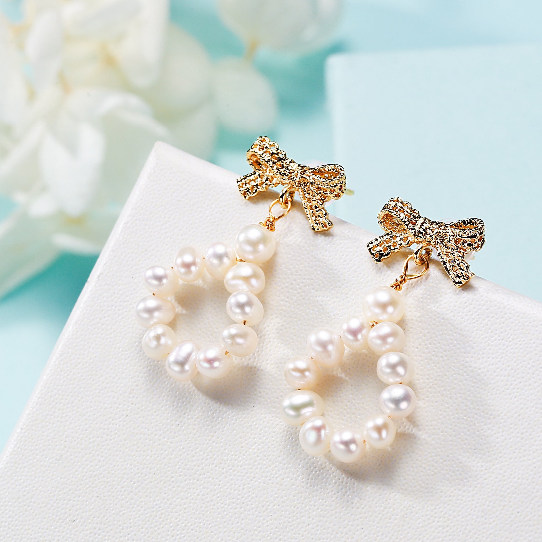 Freshwater pearl bow earrings, front view