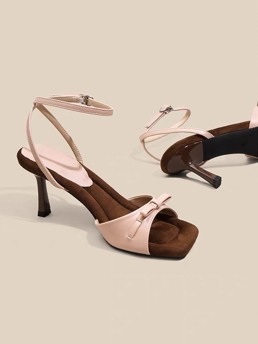 Close-up of bow strap detail on sandal